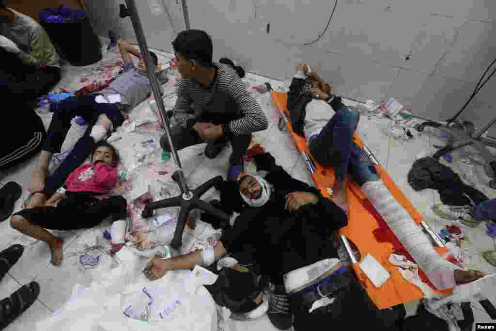 Wounded Palestinians are assisted at Nasser hospital, following Israeli strikes on Ma&#39;an school east of Khan Younis, in Khan Younis in the southern Gaza Strip.