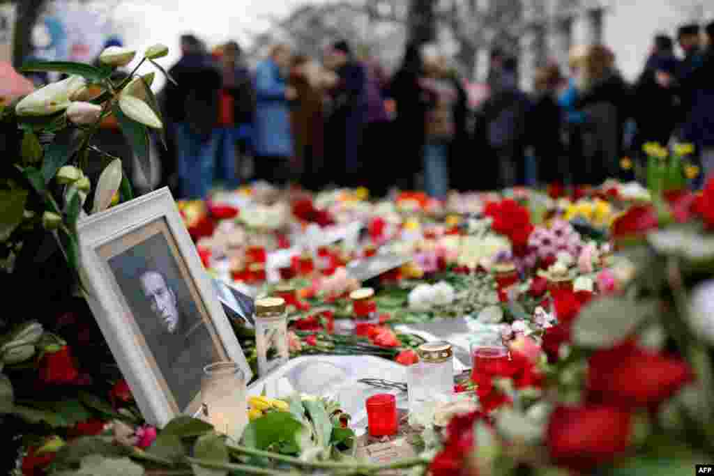 People lay flowers and candles at a memorial in front of the Russian embassy in Berlin, Germany, following the death of the Kremlin&#39;s most prominent critic Alexei Navalny in an Arctic prison.