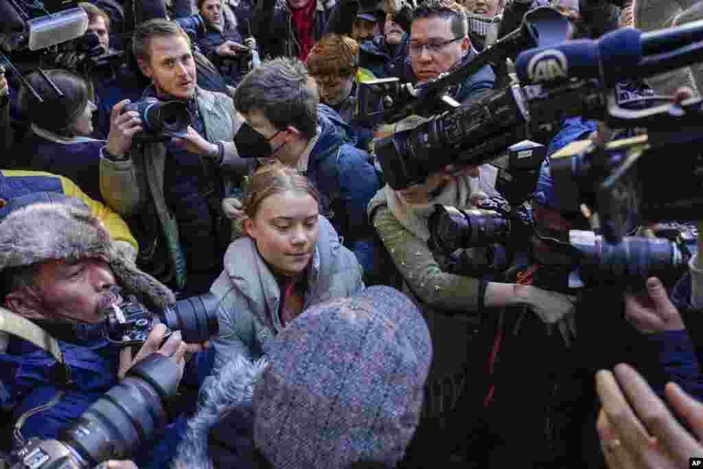 Climate activist Greta Thumberg, center, arrives at the Westminster Magistrates Court in London. She was charged with a public order offence after she was arrested while taking part in a protest against a conference in London described as &quot;the Oscars of oil.&quot;