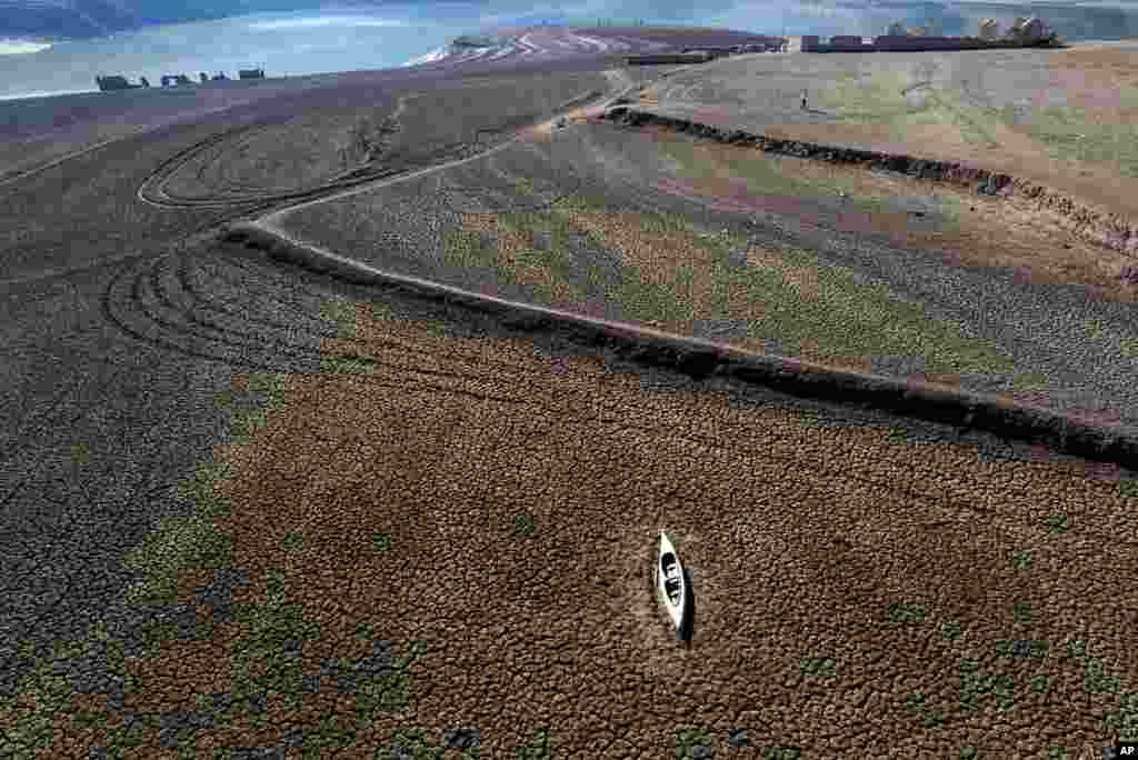 An abandoned canoe lies on the cracked ground at the Sau reservoir, which is only at 5 percent of its capacity, in Vilanova de Sau, about 100 km (62 miles) north of Barcelona, Spain.&nbsp;Barcelona and the surrounding area of Spain&#39;s northeast Catalonia are preparing to face tighter water restrictions amid a historic drought that has shrunk reservoirs to record lows.&nbsp;