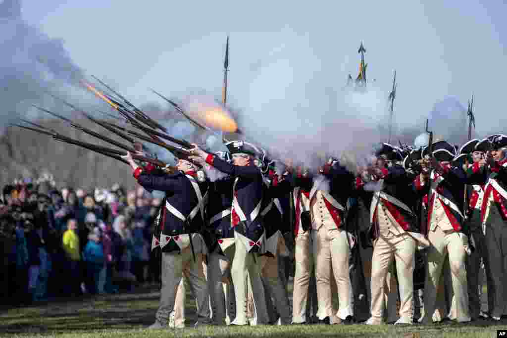 Members of Alpha Company, 3d U.S. Infantry Regiment (The Old Guard), give a firing demonstration on the Bowling Green of George Washington&#39;s Mount Vernon in Mount Vernon, Virginia.