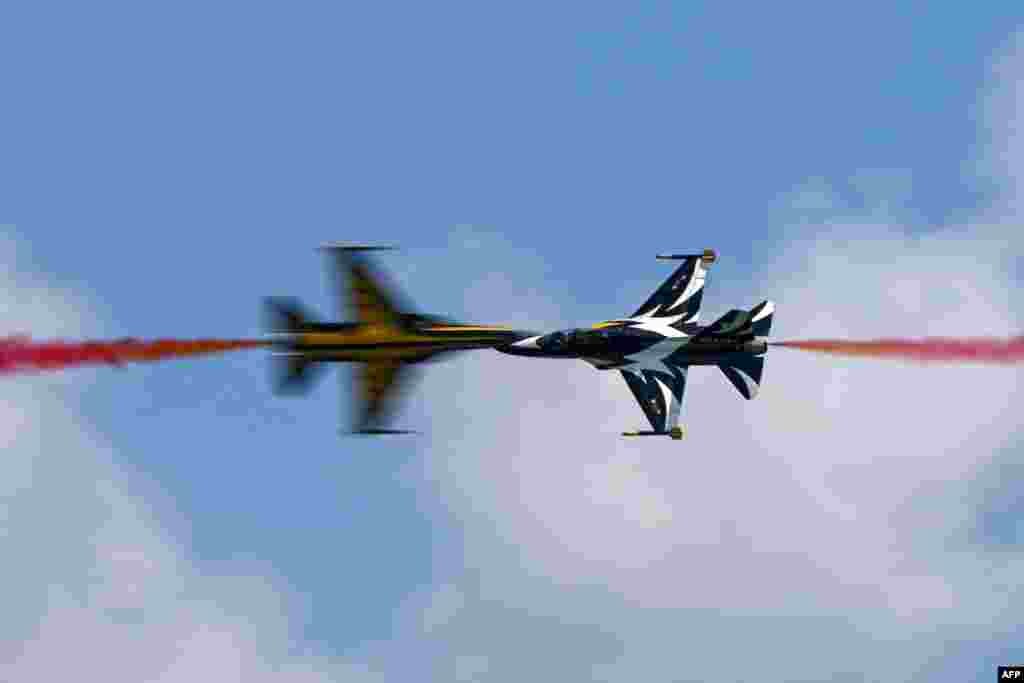 Members of South Korea&#39;s &#39;Black Eagle&#39; aerobatics team perform during a preview of the Singapore Airshow in Singapore.