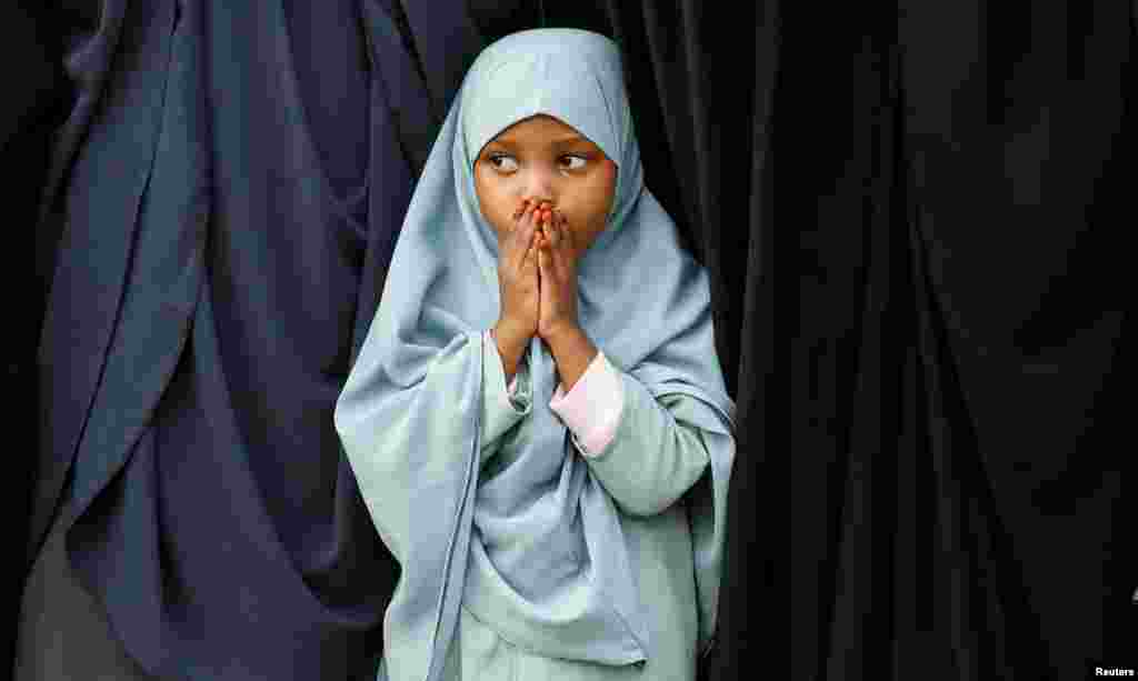 A Muslim girl attends Eid al-Fitr prayers, marking the end of the fasting month of Ramadan, at the Sir Ali Muslim Club Ground, Nairobi, Kenya.
