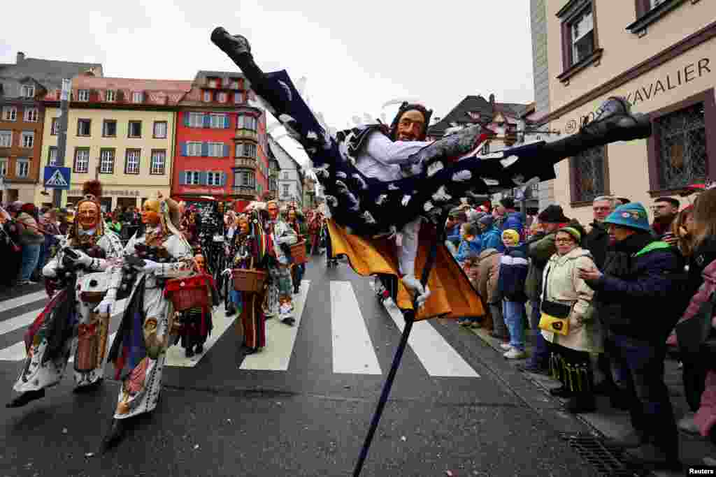 A carnival reveler performs the so-called &quot;Fools Jump&quot; during the traditional folklore procession &quot;Narrensprung&quot; in the Black Forest town of Rottweil in south-western Germany.