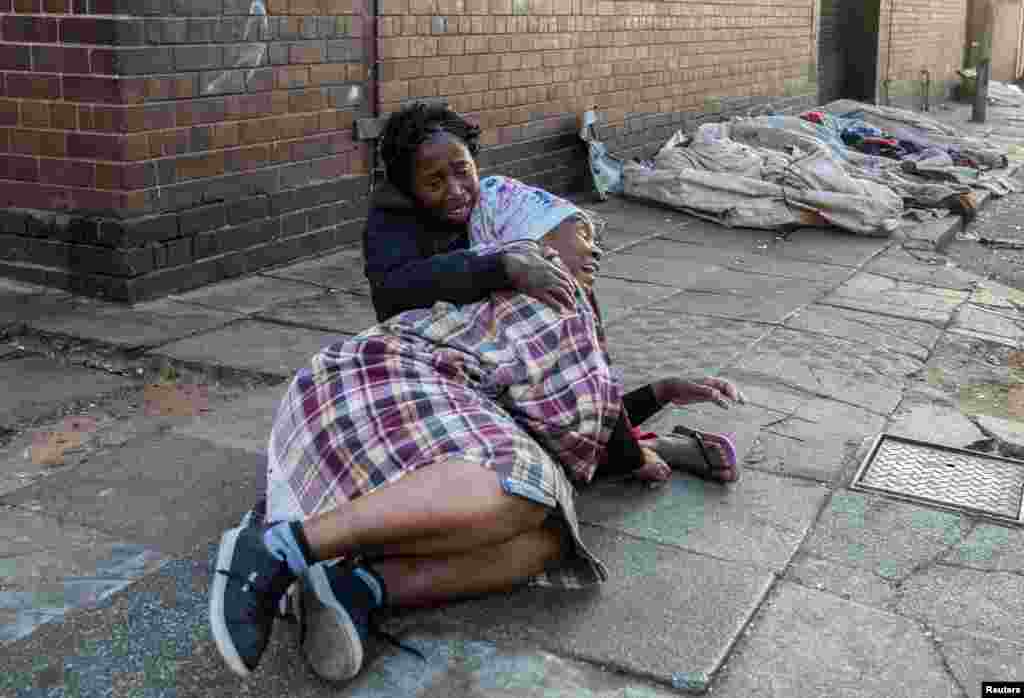 Women react after a deadly blaze in the early hours of the morning, in Johannesburg, South Africa.&nbsp;More than 70 people were killed&nbsp;overnight when&nbsp;a fire raged through a&nbsp;run-down, five-story apartment block.
