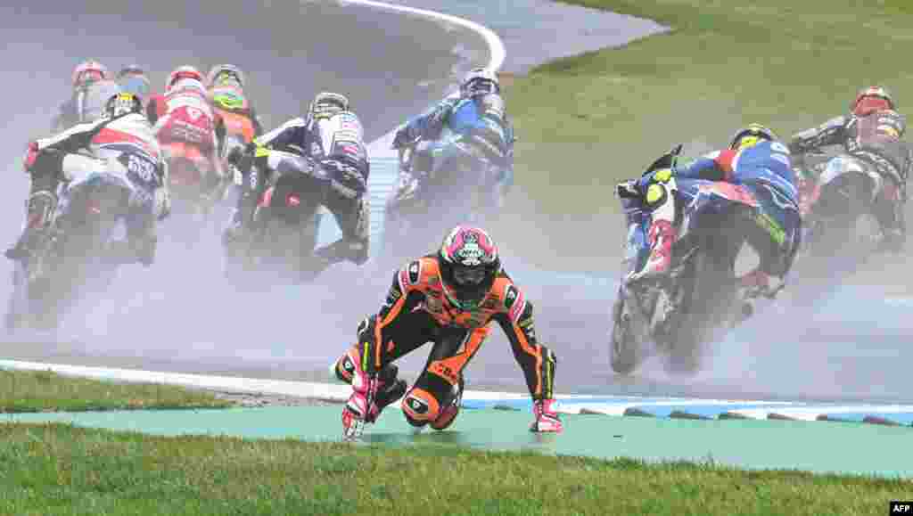Beta Tools Speed Up&#39;s Spanish rider Alonso Lopez crashes out in the early stages of the Moto2 race at the MotoGP Australian Grand Prix in Phillip Island.