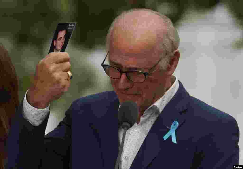 A father holds his son&#39;s picture as he attends a ceremony marking the 21st anniversary of the September 11, 2001 attacks on the World Trade Center at the 9/11 Memorial and Museum in the Manhattan borough of New York City.