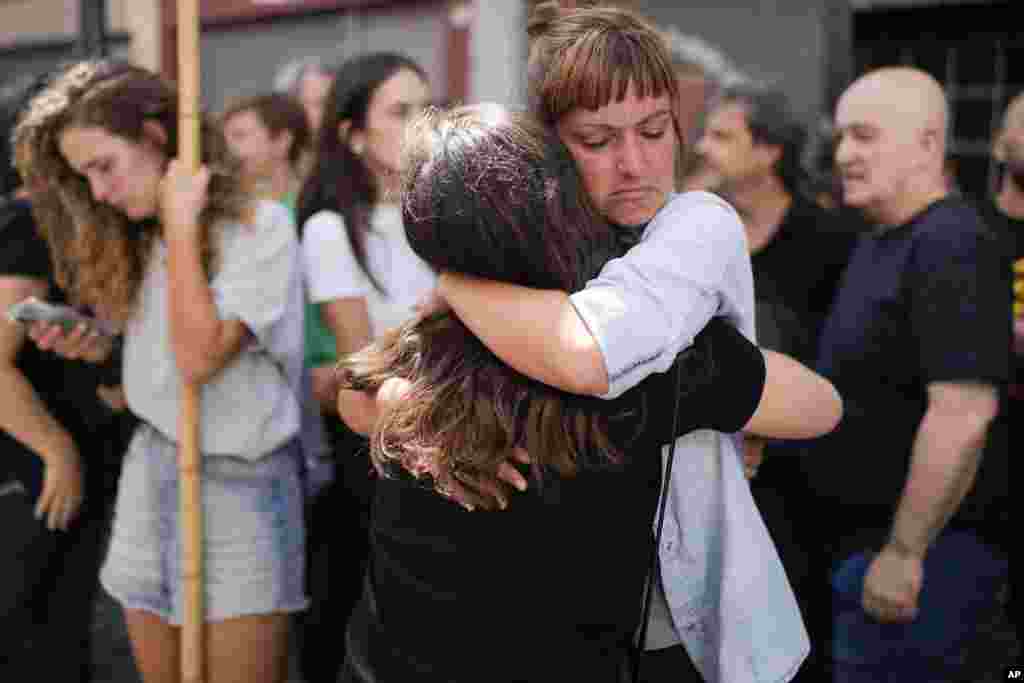Telam workers hug outside the state-run Telam news agency in Buenos Aires, Argentina.&nbsp;Télam&#39;s employees were laid off and unable to enter the facility after President Javier Milei announced its closure on March 1.