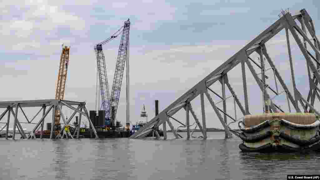 In this photo provided by the U.S. Coast Guard,&nbsp;Salvage operations on the Francis Scott Key Bridge take place, March 30, 2024, in Baltimore.&nbsp;Salvage teams used an exothermic cutting torch to systematically separate sections of the steel bridge, which will be taken to a disposal site.