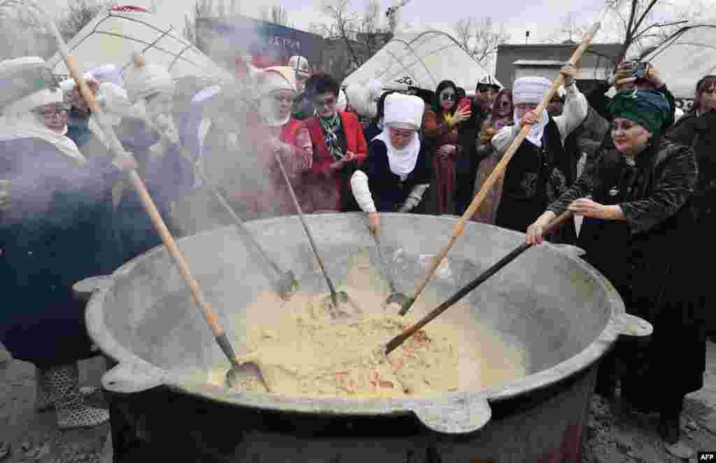 Participants cook the traditional dish &#39;Sumulyk&#39; during the celebrations of Nowruz (New Year) in Bishkek, Kyrgyzstan.