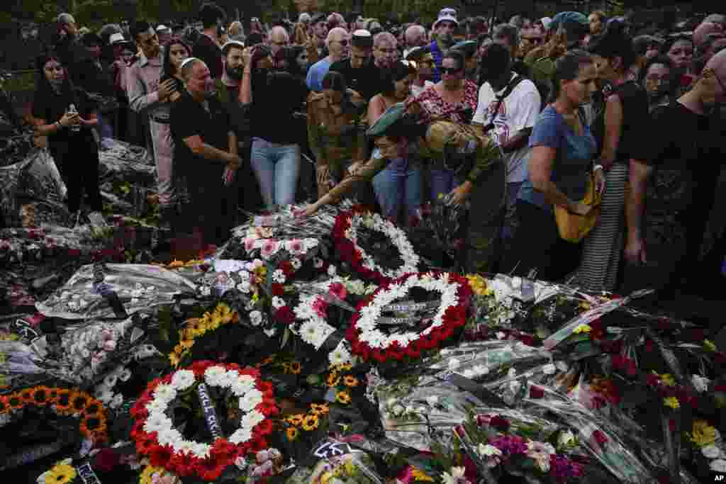 Mourners gather around the graves of Sgt. Yam Goldstein and her father, Nadav, during their funeral in Kibbutz Shefayim, Israel.&nbsp;Yam and her father were killed by Hamas militants at their house on Oct. 7.&nbsp;