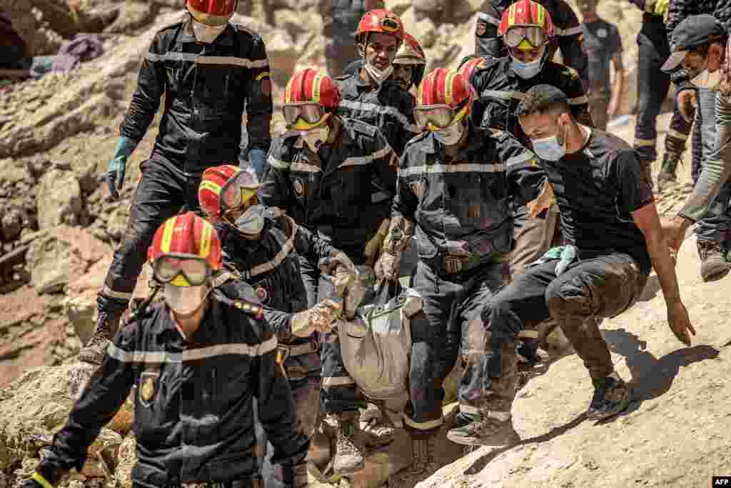Rescue workers carry a body recovered from the rubble of an earthquake-damaged house in Imi N&#39;Tala village near Amizmiz, Morocco.&nbsp;Rescue teams stepped up a massive effort to bring relief to devastated mountain villages as the chances faded fast for finding survivors from the powerful earthquake which killed 2,900 people and left hundreds of thousands homeless.