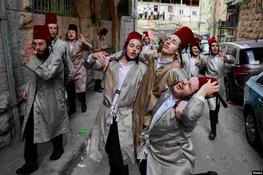 Ultra-Orthodox Jewish men mark the Jewish holiday of Purim, a celebration of the Jews&#39; salvation from genocide in ancient Persia, in the Mea Shearim neighborhood of Jerusalem.
