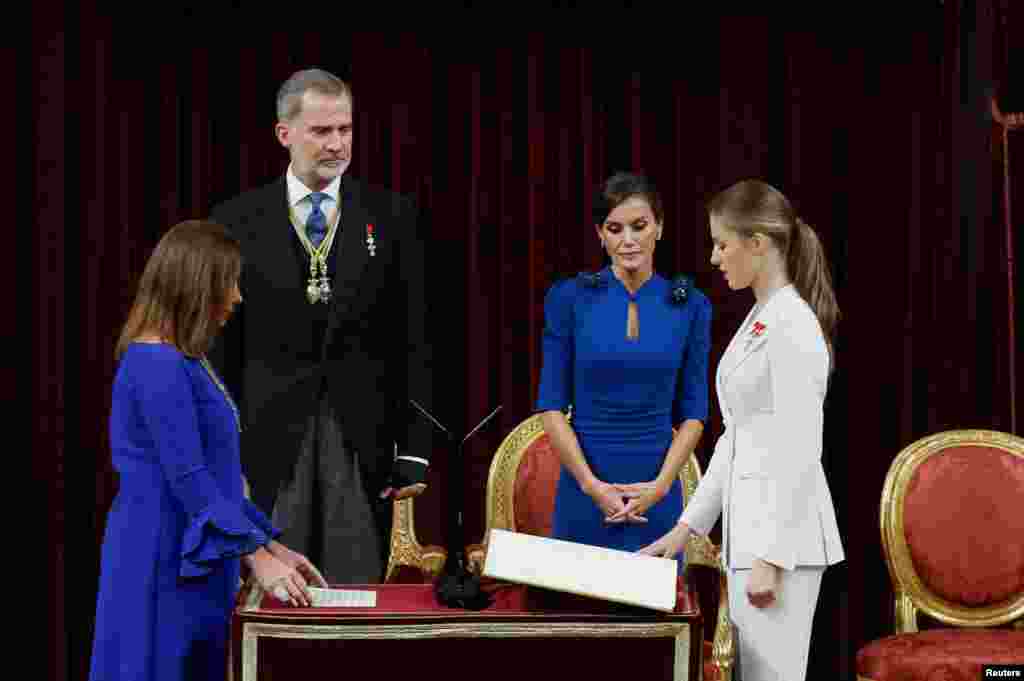 Spain&#39;s Princess Leonor swears an oath to the constitution on her 18th birthday as her parents Spain&#39;s King Felipe, Queen Letizia look at her at the parliament in Madrid.