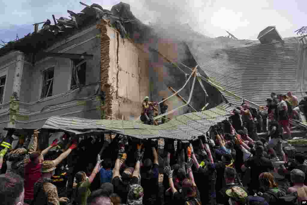 Emergency services work at the site of Okhmatdyt children&rsquo;s hospital hit by Russian missiles, in Kyiv, Ukraine.
