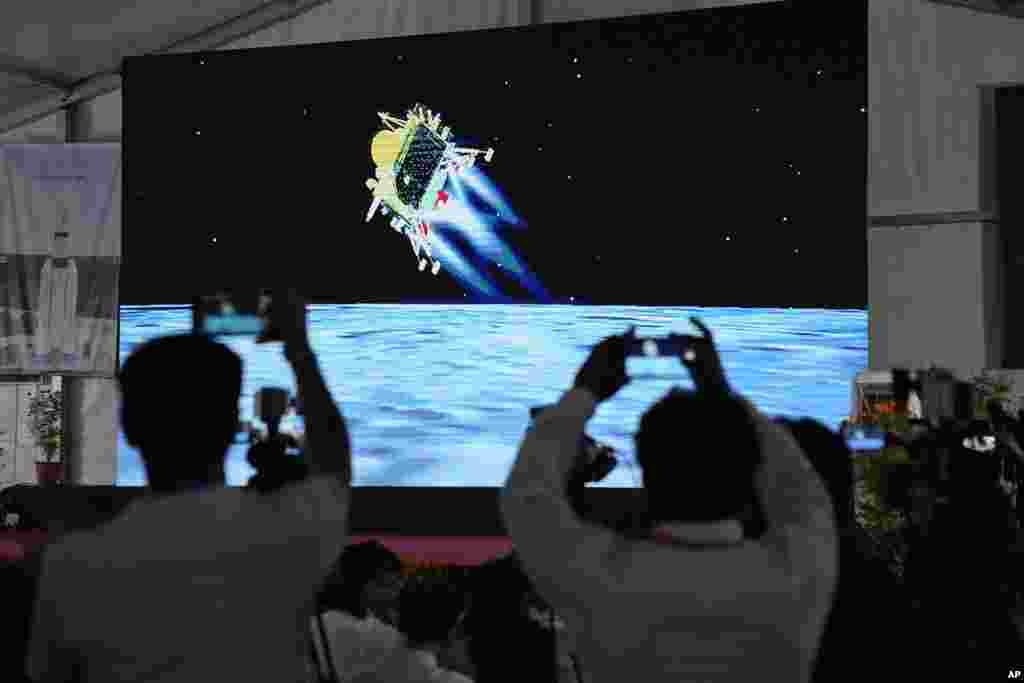 Journalists film the live telecast of spacecraft Chandrayaan-3 landing on the moon at ISRO&#39;s Telemetry, Tracking and Command Network facility in Bengaluru, India.&nbsp;India lands a spacecraft near the moon&rsquo;s south pole, becoming the fourth country to touch down on the lunar surface.