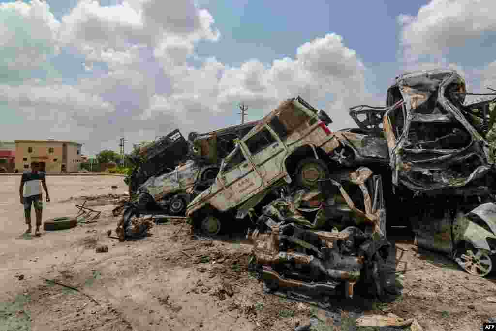 A man walks past burned vehicles after violent communal clashes in Nuh, India.&nbsp;At least four people have been killed in violent clashes between Hindus and Muslims near the capital New Delhi, police said.&nbsp;