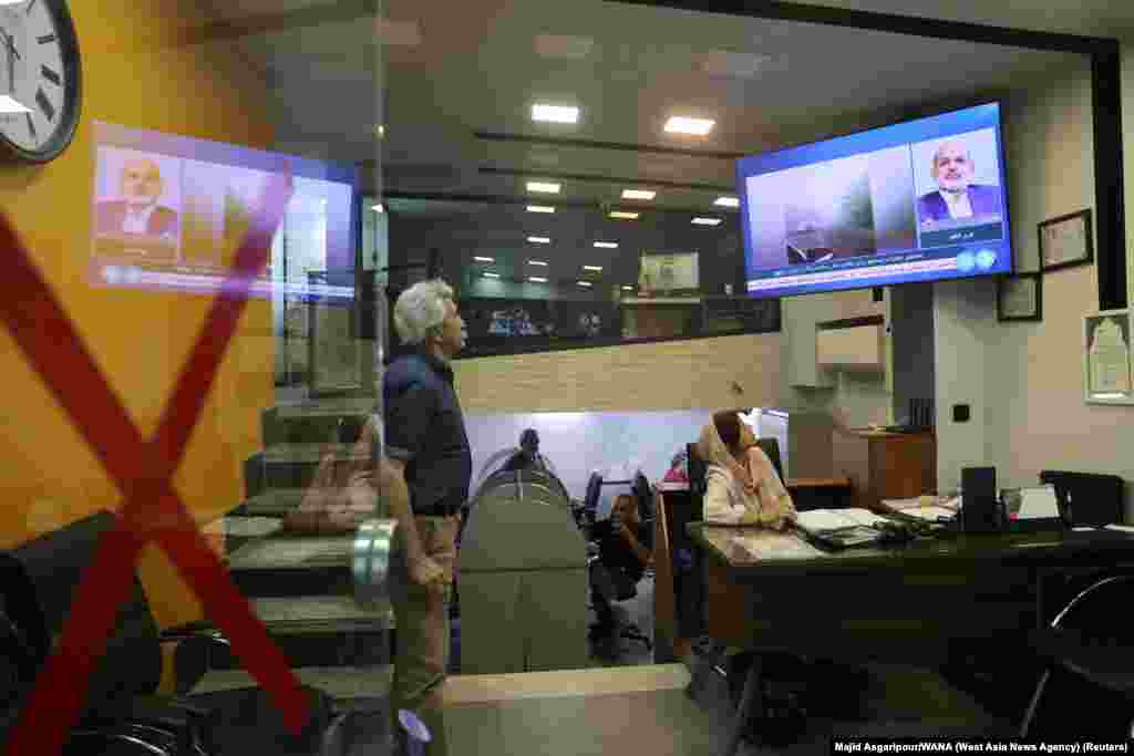 People follow the news of a crash of a helicopter carrying Iran&#39;s President Ebrahim Raisi, on a TV in a shop in Tehran.&nbsp;A helicopter carrying&nbsp;Iranian President Ebrahim Raisi and his foreign minister crashed as it was crossing mountain terrain in heavy fog, an&nbsp;Iranian official told Reuters, and rescuers were struggling to reach the site of the incident.
