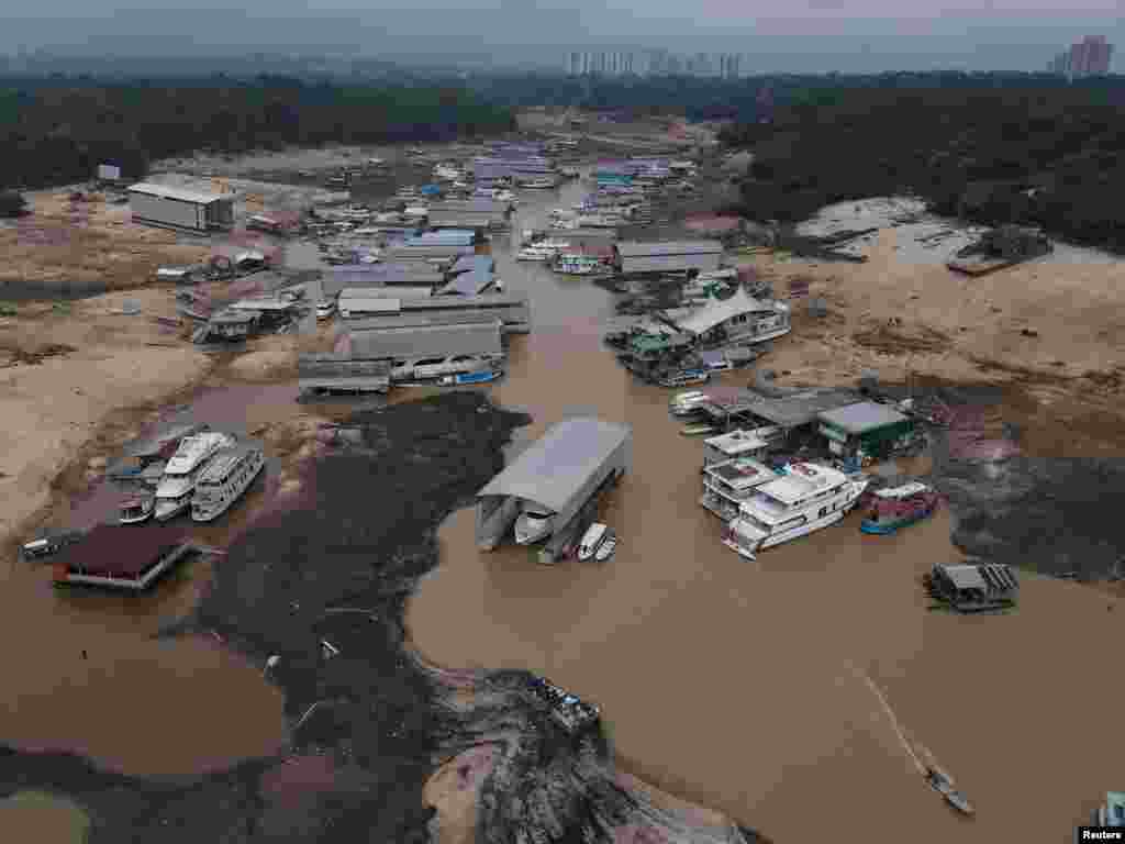 Boats and houseboats are seen stranded at David&#39;s Marina as the water level at a major river port in Brazil&#39;s Amazon rainforest hit its lowest point in at least 121 years, at the Rio Negro river in Manaus, Oct. 16, 2023.
