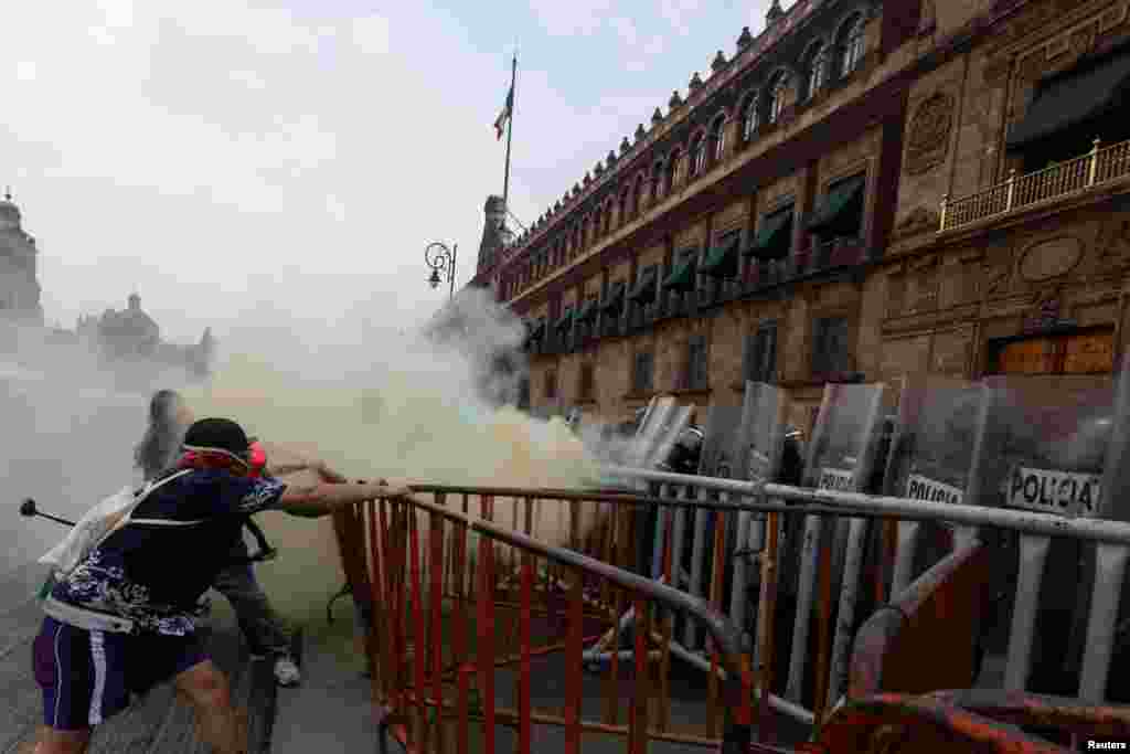Police officers clash with protesters in front of the National Palace during the International Transgender Day of Visibility in Mexico City, Mexico, March 31, 2024. 