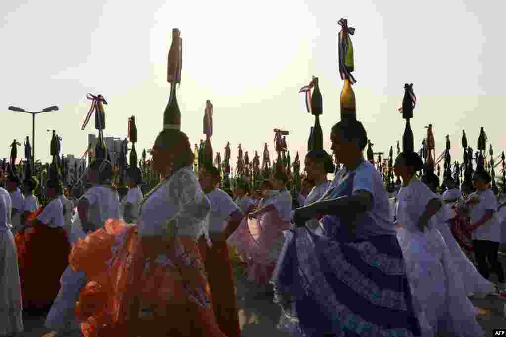 Bottle dancers attempt to set a record at the Official World Record Association&nbsp;on the first edition of the National Day of the Bottle Women at the Bicentennial Park in Asuncion, Paraguay, Sept. 17, 2023. Paraguay obtained an Official World Record when 580 dancers balanced 2200 bottles on their heads.