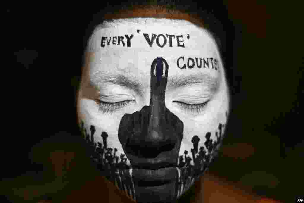 A college student has her face painted to spread awareness for first generation voters during an election campaign ahead of India&#39;s upcoming national elections in Chennai.