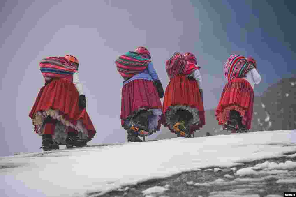 Elena Quispe Tincuta, 26, Julia Quispe Tincuta, 35, Alicia Quispe Tincuta, 40, and Pasesa Alana Llusco, 37, climb the snow-capped Huayna Potosi mountain, near El Alto, Bolivia. The cholita climbers&#39;s goal is to reach the summit of Everest in 2025.