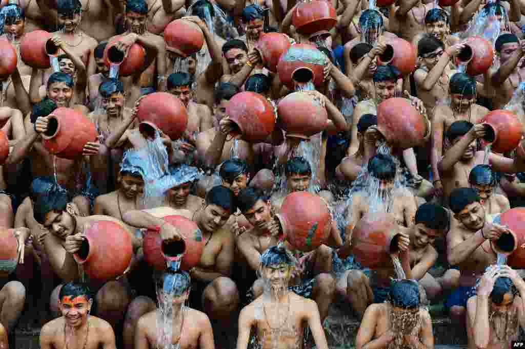 Students from the Swaminarayan Gurukul school take part in a &#39;Magh Snan&#39; or holy bath in Ahmedabad, India.