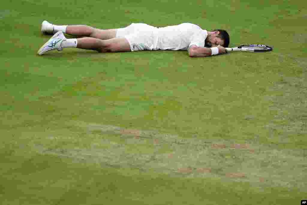 Serbia&#39;s Novak Djokovic lays on the court after slipping against Italy&#39;s Jannik Sinner in a men&#39;s singles semifinal match on day 12 of the Wimbledon tennis championships in London.&nbsp;Djokovic went on to win the match.