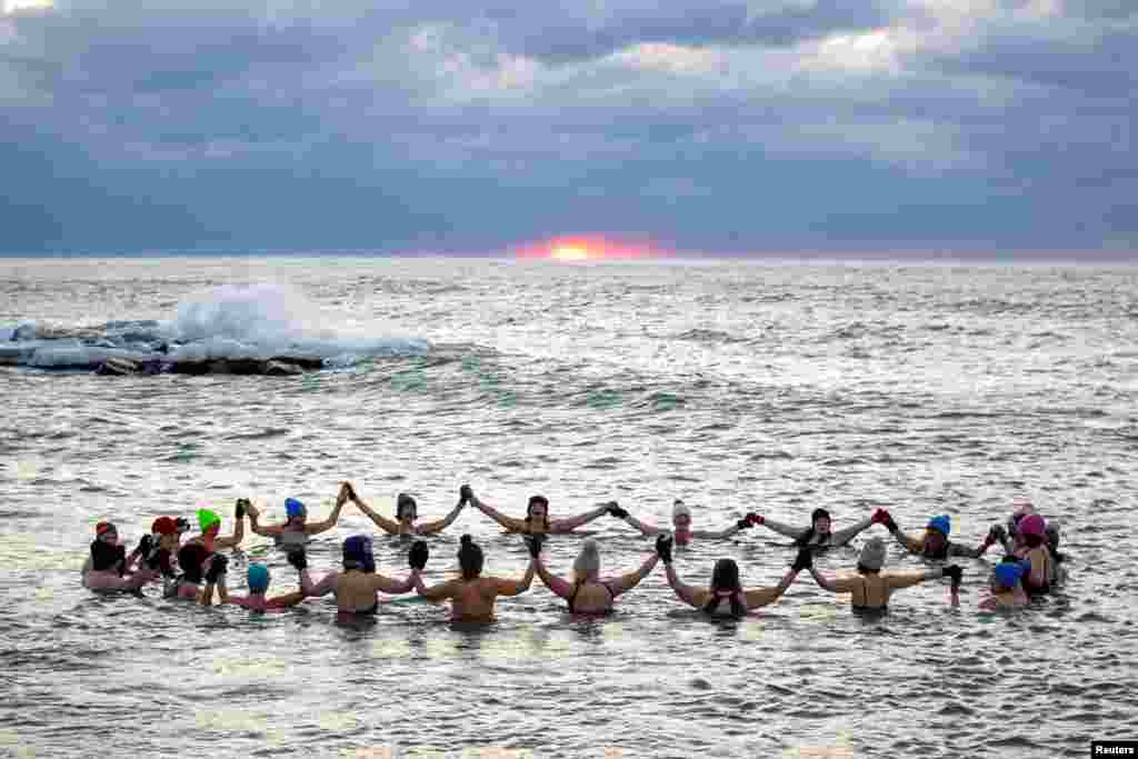 A group consisting mostly of women, who call themselves &quot;The Endorphins,&quot; gather for a sunrise swim in the chilly waters of Lake Ontario during freezing temperatures in Toronto, Ontario, Canada.