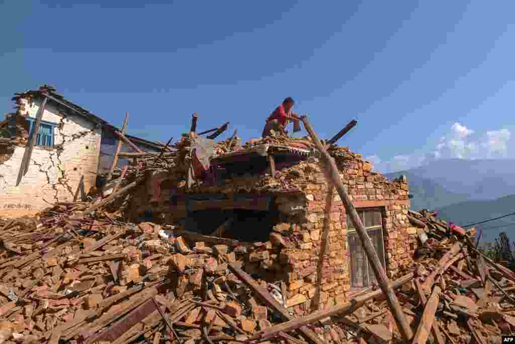 A survivor searches for belongings through the ruins of her house following an earthquake in Khalanga of Jajarkot district, Nepal.&nbsp;At least 157 people were killed in isolated western districts of the Himalayan country when the 5.6-magnitude earthquake hit late November 3.&nbsp;