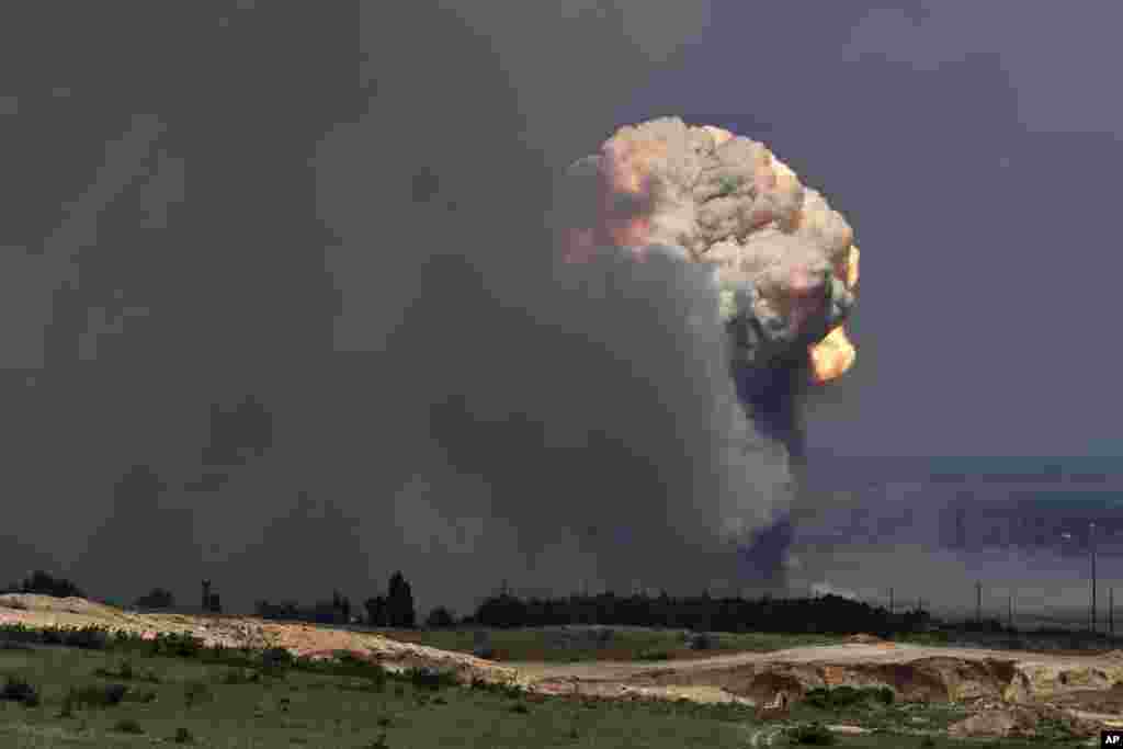 A plume of smoke rises over an ammunition depot where explosions occurred at the facility in Kirovsky district in Crimea.&nbsp;Russian emergency officials in Crimea said more than 2,200 people were evacuated from four villages because of a fire at a military facility.&nbsp;