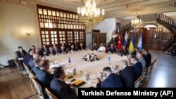 Russian, top left, and Ukranian, right, delegations meet along with United Nation observers, left, and Turkish Defense Ministry members in Istanbul, Turkey, July 13, 2022.