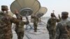 In this photo released by the U.S. Air Force, Col. Todd Benson, the U.S. Air Force Central Command director of space forces, center, leads airmen through their enlistment ceremony as they became members of the Space Force at Al-Udeid Air Base, Qatar…