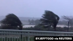 Trees are buffeted by strong winds as Hurricane Isaias hits the Bahamas on July 31, 2020 in this still image taken from social media video, filmed from the Grand Isle Resort and Spa at Emerald Bay, Great Exuma.