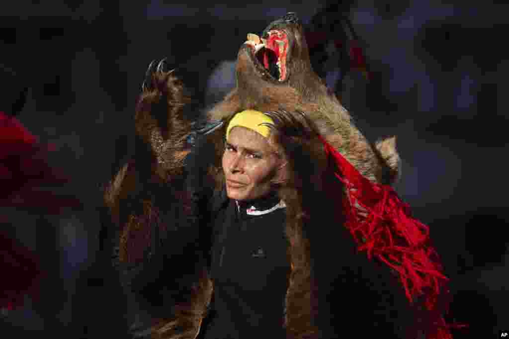 A person from northern Romania performs the bear dance Christmas and New Year&#39;s ritual in Bucharest, Romania, Dec. 25, 2021.