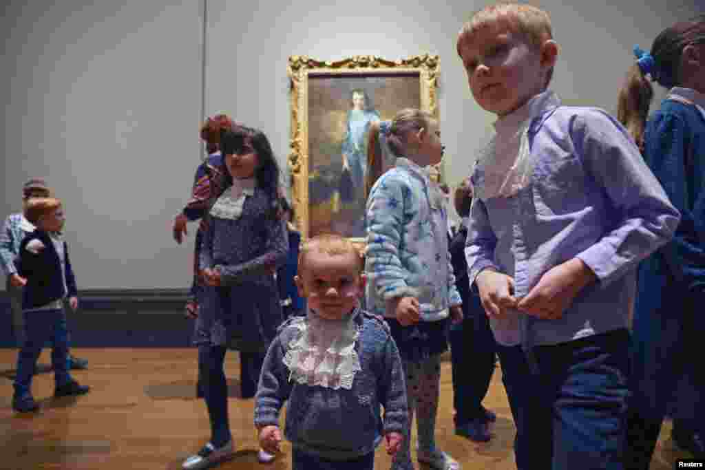 Children walk in front of Thomas Gainsborough artwork &lsquo;The Blue Boy&rsquo; on its centenary comeback to the UK, at The National Gallery in London.