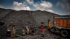 Indian laborers load coal into a truck in Dhanbad, an eastern Indian city in Jharkhand state, Friday, Sept. 24, 2021. (AP Photo/Altaf Qadri)