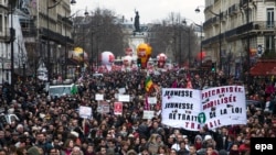 Des milliers de personnes manifestent avec une affiche mentionnant : jeunesse précarisée - jeunesse mobilisée - retrait de la législation du travail, contre un projet de loi du travail controversé du gouvernement près de la Place de la République, à Paris