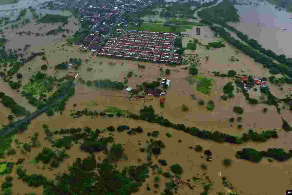 Flood waters submerge the city of Itapetinga in the southern region of the state of Bahia, Brazil, Dec. 26, 2021. The Bahia state government&#39;s press office said heavy rains have caused floods that have killed 18 people and affected more than 30 cities since early November, forcing more than 4,000 from their homes and complicating access to some communities.