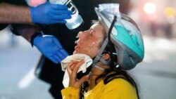 A medic treats Black Lives Matter protester Lacey Wambalaba after exposure to chemical irritants deployed by federal officers at the Mark O. Hatfield United States Courthouse, July 24, 2020, in Portland, Oregon.