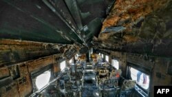 EDITORS NOTE: Graphic content / A general view of a burned out railway coach after it allegedly set on fire by opposition activists, in Dhaka on December 19, 2023.