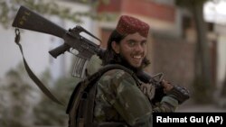 A Taliban fighter patrols in Wazir Akbar Khan in the city of Kabul, Afghanistan, Wednesday, Aug. 18, 2021. 