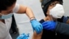 A healthcare worker administers a shot of the Moderna COVID-19 Vaccine to a woman at a pop-up vaccination site operated by SOMOS Community Care during the coronavirus disease (COVID-19) pandemic in Manhattan in New York City, New York, U.S., January 29, 2