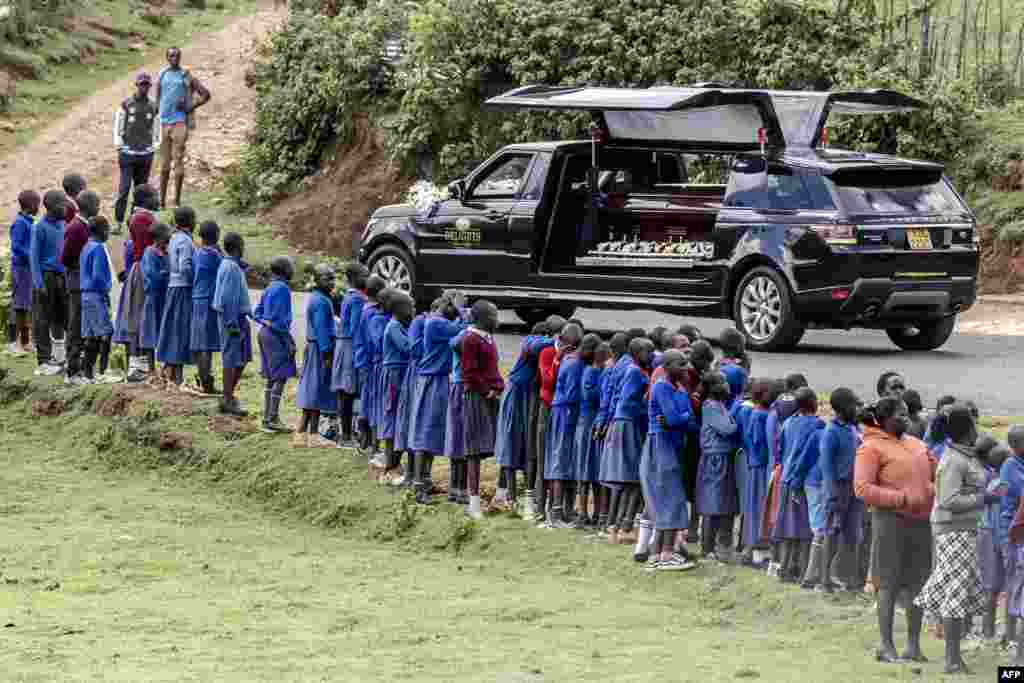 Students line up next to the road to see the hearse carrying the coffin of late marathon runner Kelvin Kiptum during his funeral proceedings in the village of Chepkorio.&nbsp;Kenya&#39;s world-record holding marathon runner, a prodigy who ran three of the seven fastest marathons in history and was ranked first among the world&#39;s men&#39;s marathon runners, tragically died in a car crash in Kenya on Feb. 11, 2024, at the age of 24.