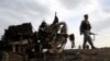 Afghan security forces gather at the site of Monday's attack near the Bagram Air Base, north of Kabul, Afghanistan, April 9, 2019.