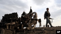 Afghan security forces gather at the site of Monday's attack near the Bagram Air Base, north of Kabul, Afghanistan, April 9, 2019.